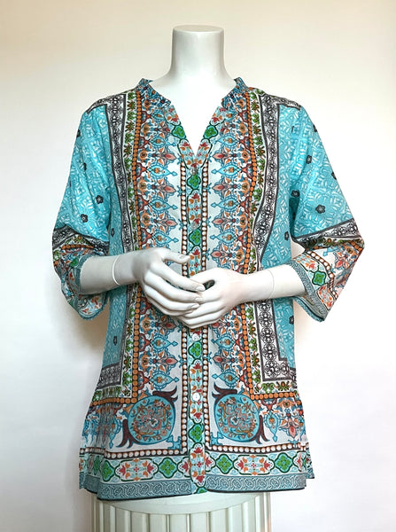 This gorgeous, lightweight tunic made of 100% Indian block print cotton voile is sure to be your favorite garment this summer! It is fitted at the shoulders and continues in a flattering A-line. It has a split neckline on a small mao collar, slits at the side seams, and 3/4 sleeves. This tunic is adorned with mother-of-pearl buttons down the front and the print has an Eastern vibe to it with medallions and flowers in shades of turquoise, greens, terracotta, reds, and brown on an off-white background.