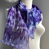 It has been created with Shibori dyeing technique on 100% pure silk crinkle chiffon and is totally unique. A piece of art to wear!  The silk chiffon is Summer weight (5 mm) and light and diaphanous with a crinkle texture that gives it body, interest, and charm. The finely finished hand-rolled piece measures flat at 22” X 72” but looks narrower with its crinkles. Mix of hyacinth purple and blue and a bit of white