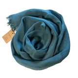 With its 100% European stonewashed woven linen fabric, this scarf will become only softer with every wash. The colour is a medium teal blue. Wash your linen on the gentle cycle with non-chloride detergent, and tumble dry on low settings to help your linen become softer. Wrinkles are part of linen natural charms, but if you prefer a pressed look, iron with medium heat or use a steamer. 18" x 80" with fringe at both ends.  Handmade in India 