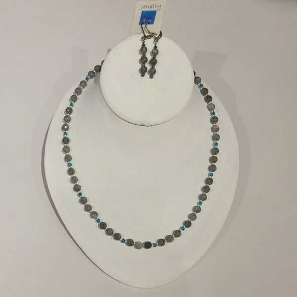 Single strand necklace of faceted labradorite in varying shades of grey spaced with bright blue crystals and clear seed beads, and matching short drop earrings 