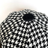 Details of the big black boiled wool covered button trim on top of the hat.