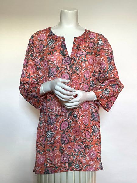 This delightful Summer tunic is 100% lightweight, block-printed Indian cotton. It's a terrific,versatile cut which is wearable with leggings, capris, shorts, skirts, you name it! It has a flattering shoulder fit from which it flares slightly into a body-skimming silhouette with side seams open over the hips. It's washable in cold water, and hang dries quickly. This print is a fun splashy floral print in peach, the Pantone colour of the year for 2024, with touches of pink and teal for contrast.