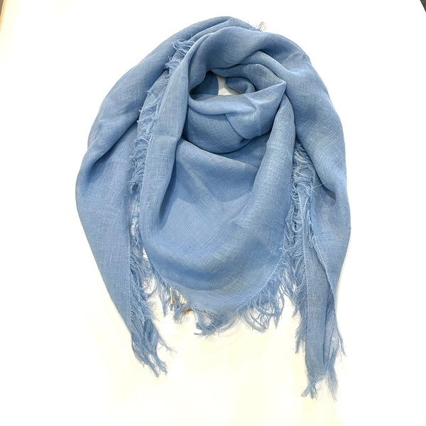 With its 100% European stonewashed woven linen fabric, this scarf/shawl will become only softer with every wash. In a bright mid-tone blue colour. Easy to care for, wash your linen on the gentle cycle with non-chloride detergent, and tumble dry on low settings to help your linen become softer. Wrinkles are part of linen natural charms, but if you prefer a pressed look, iron with medium heat or use a steamer. 55"X55" with fringe on all sides.  Handmade in India