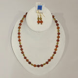 Single strand necklace in various shades of faceted orange carnelian spaced with gold coloured beads and matching short drop earrings