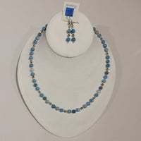 Single strand necklace of varying shades of light blue larimar quartz spaced with silver seed beads and occasional round silver bead, and matching short drop earrings 