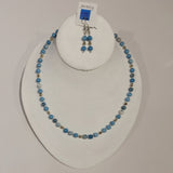 Single strand necklace of varying shades of light blue larimar quartz spaced with silver seed beads and occasional round silver bead, and matching short drop earrings 