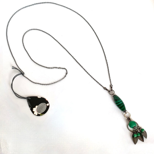 Find this handmade necklace by local artisan Khalia Scott at Eclection Ottawa. The gemstone theme is named "Positivity " and it is part of a collection created to foster positive vibes in the year to come. It has natural, rare, polished and hardened semi-precious oblong malachite beads, small round malachite beads and matte Tibetan glass beads all in a rich shade of green. It is finished off with zinc alloy findings and presented on a fine zinc alloy chain.  Measuring 33" total