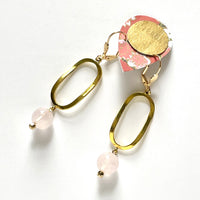 Find these handmade dangle earrings by local artisan Khalia Scott at Eclection Ottawa.  These earrings are fashioned of polished spherical rose quartz beads and presented with a funky, wavy gold-plated oval element and gold-plated lever-backed hooks. They measure approximately 2 1/2" in length and weigh 6g/pair.