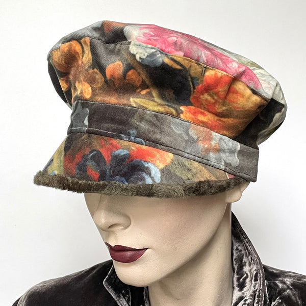 Find this one-of-a-kind, handmade “Captain” hat by Ottawa artisan Sue Scott at Eclection Ottawa. It is fashioned in a beautiful Baroque floral print in polyester panne velvet in tones of rust, greys, sage and plum. Its under-peak is a faux fur in a dark sage shade with a swirl texture. The shape is a classic two-part crown with some volume and a front peak. Fully lined with a satiny Kasha lining that stops wind for added warmth. Size-small: Approximately 21 1/4".  Dry clean only.