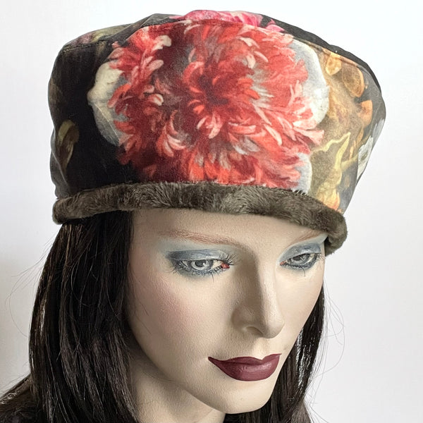 Find this one-of-a-kind, handmade “Rideau” beret by Ottawa artisan Sue Scott at Eclection Ottawa. It is fashioned in a beautiful Baroque floral print panne velvet in tones of rust, greys, sage and plum. It is trimmed with a polyester faux fur in a dark sage shade with a swirl texture, and has an adjustable cord so it can be worn in a variety of ways. It is fully lined with a thick and tightly woven wind proof Kasha lining. Size-medium: ranging from 21 ½’’- 22 ¾.’’