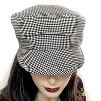 Find this Crumper cap handmade by artisan Sue Scott at Eclection Ottawa. It is fashioned in mid-weight 100% linen in a timeless black and white houndstooth pattern that will never go out of style. The shape is a straight-sided, flat-topped crown, with a classic front peak that protects from the sun. This hat is fully lined with satin and has an elastic at the back for a comfy snug fit. Size small/medium that ranges approximately from 21" to 22 1/4"