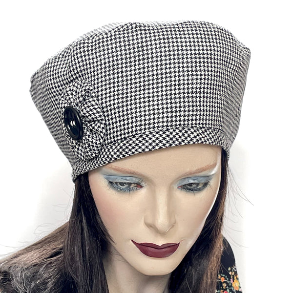 Find this handmade “Rideau” beret by Ottawa artisan Sue Scott at Eclection Ottawa. It is fashioned in mid-weight 100% linen in a timeless black and white houndstooth pattern that will never go out of style. It is finished off with a hand-sewn cockade rosette in the same fabric with a matching vintage button at its center. It has an adjustable interior ribbon and can be worn in various ways. Fully lined with satin. Size-medium: ranging from 21 ½’’- 22 ¾.