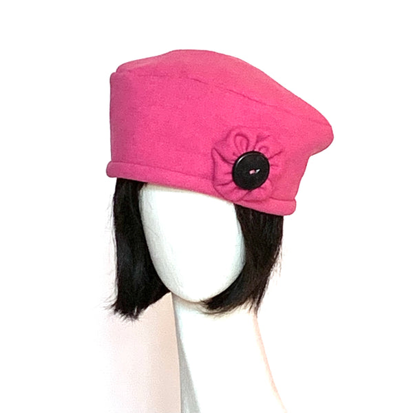 One-of-a-kind, handmade “Rideau” beret by Ottawa artisan Sue Scott. This cozy hat is fashioned in a cheerful wool/polyester blend that is the perfect pop of colour in the cold, grey winter months. It is finished off with a hand-sewn rosette in the same fabric that sports a black vintage button at its centre.  It is fully lined with Kasha lining that’s easy on the hair and protects from the wind for even more warmth. Size-medium: ranging from 21 ½’’- 22 ¾" and features an adjustable cord. 