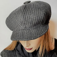 Find this one-of-a-kind Casquette, handmade by local artisan Sue Scott at Eclection Ottawa. It is fashioned in a charcoal wool blend fabric with a waffle texture which adds a touch of coziness to this classic hat. The shape is an eight-part crown, with some volume and a front peak. It is finished off with a vintage leather-covered button on top and is fully lined with a thick windproof Kasha lining for added warmth. Size medium-large: Approximately 22 1/2’’ with an elastic in the back.