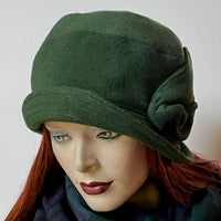Find this One-of-a-kind, handmade “Cloche” hat by Ottawa artisan Sue Scott at Eclection Ottawa. This hat embodies the beautiful 1920’s classic style. It is fashioned in a soft conifer green cashmere/wool blend boucle fabric and features a hand-sewn swooping bow in the same fabric, a small, top-stitched style-able brim and it is fully lined with a satiny, flannel-backed Kasha lining that’s easy on the hair and stops the wind. Size-medium: Approx 22 ½.’’ 