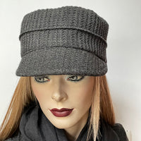 Find this one-of-a-kind Crumper hat, handmade by local artisan Sue Scott, at Eclection Ottawa. It is fashioned in a fun charcoal wool blend fabric with a rich waffle texture which adds a touch of coziness to this classic hat. The shape is a straight-sided, flat-topped crown, with a classic front peak. It is finished off with a satiny, flannel-backed Kasha lining that’s easy on the hair and stops wind for added warmth. Size-medium: Approximately 22 1/2" Dry clean only.