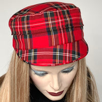 This one-of-a-kind hat, handmade by local artisan Sue Scott, is called the "Crumper". It is fashioned in a fun red plaid wool/cotton blend which is perfect for adding a bit of colour in the colder months. The shape is a straight-sided, flat-topped crown, with a classic front peak that conveniently keeps snow off of your eyelashes. Fully lined with a satiny, flannel-backed Kasha lining that’s easy on the hair and protects from the wind for added warmth. Size-medium, approximately 22 1/4"