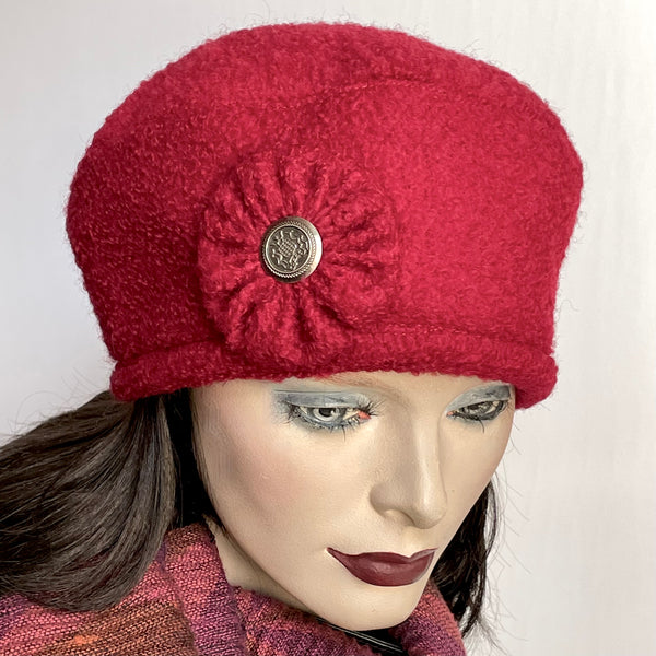 Find this one-of-a-kind, handmade “Rideau” beret by Ottawa artisan Sue Scott at Eclection Ottawa.  It is fashioned in a fun deep red wool blend fabric with a rich and cozy boucle texture and is finished off with a hand-sewn cockade trim in the same fabric adorned with a vintage metal button at its centre. The Rideau beret also features an adjustable cord and a thick and tightly woven windproof Kasha lining that's easy on the hair and adds some warmth. Size-medium: ranging from 21 ½’’- 22 ¾.’’