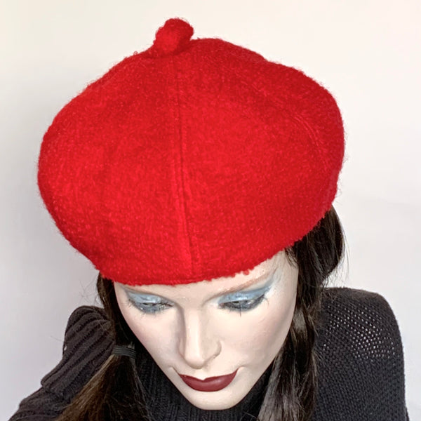 Find this handmade"Gigi" beret by local artisan Sue Scott at Eclection Ottawa. It is fashioned in a bright red boiled wool with a rich bouclé texture which is perfect for adding a bit of colour in the colder months. The shape is a six-part voluminous crown and the trim is a loop on top made in the same fabric. Fully lined with a satiny, flannel-backed Kasha lining that’s easy on the hair and protects from the wind for added warmth. Size-medium: Approximately 22 1/2’’ with an elastic inside.  