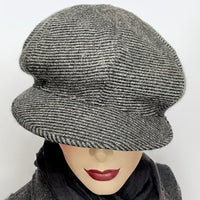 Find this one-of-a-kind Casquette, handmade by local artisan Sue Scott at Eclection Ottawa. It is fashioned in a grey and black striped wool and cashmere blend fabric. The shape is an eight-part crown, with some volume and a front peak. It is finished off with a vintage 4-hole button on top and is fully lined with a thick and tightly woven Kasha lining for added warmth. Size medium-large: Approximately 22 1/2’’ with an elastic in the back so it can go a little larger. 