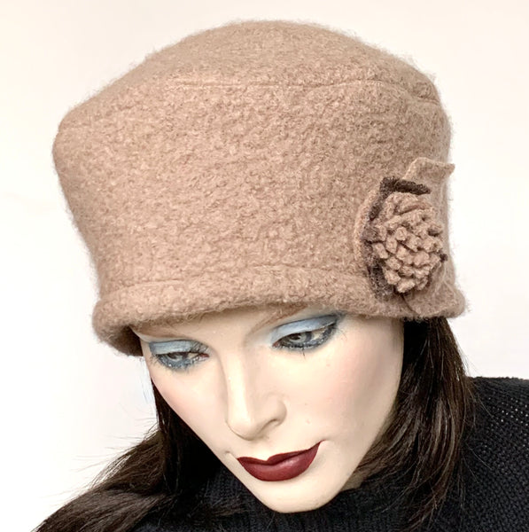 One-of-a-kind, handmade “Rideau” beret by Ottawa artisan Sue Scott, at Eclection Ottawa. It is fashioned in a heavyweight beige-coloured boiled wool perfect for the colder months. It is finished off with a beautiful, hand-sewn flower trim in the same fabric. Elegance meets fun for easy daywear with this beret that can be worn in a variety of ways. Wind-resistant lining. Size-medium: ranging from 21 ½’’- 22 ¾" and features an adjustable cord.