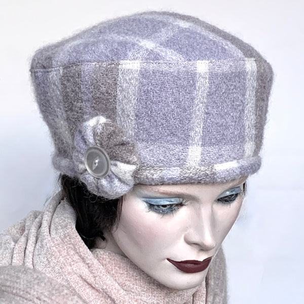 Find this handmade “Rideau” beret by Ottawa artisan Sue Scott at Eclection Ottawa. This hat is fashioned in a lovely mohair/wool blend in tones of lavender, taupe and cream. It is finished off with a hand-sewn rosette in the same fabric that sports a faux mother-of-pearl vintage button at its centre. Lined with wind-resistant fabric. Size-medium: ranging from 21 ½’’- 22 ¾" and features an adjustable cord. 