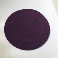 The Basque Beret has the most classic shape and is made of 100% felted wool and finished with rolled edging. Dark Dahlia - Dark Purple