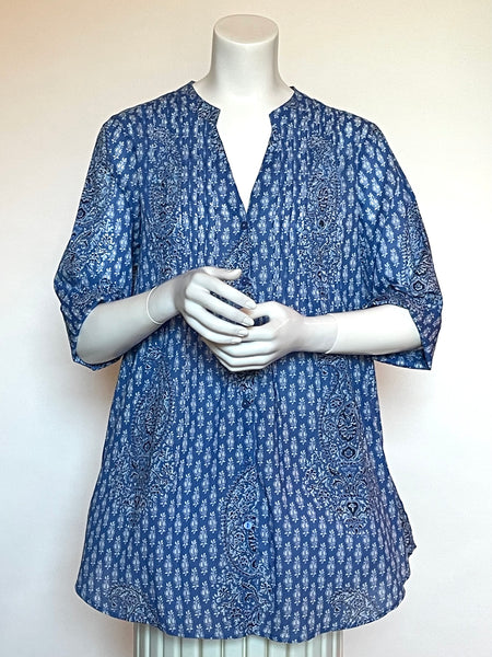 Find this wonderful Summer blouse is 100% lightweight, block-printed Indian cotton voile at Eclection Ottawa. It has small pleats in the front and halfway down the center back make the overall shape have a nice fit over the shoulders and float out over the hips. Other awesome details include a small Mandarin collar, buttons down the front, half sleeves with a charming turn up detail and full-sized pockets in the side seams! Seen here in a classic small paisley print in blues.
