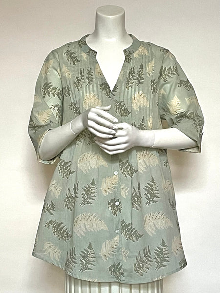 This wonderful Summer blouse is 100% lightweight, block-printed Indian cotton voile. It has a roomy yet flattering cut, that keeps you cool in style. Small pleats in the front and halfway down the center back make the overall shape a nice fit over the shoulders and float out over the hips. Other awesome details include a small Mandarin collar, buttons down the front, half sleeves, and pockets in the side seams! Seen here in a an intriguing mix of soft greens including celadon in a fern motif.