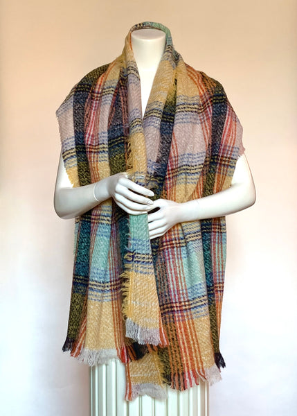 Wrap yourself in this soft and cozy blanket scarf this winter. Its generous size of 24X71 inches and its multicoloured plaid in tones of buttery yellow, orange, soft aqua, chambray and black allow for versatile wear.  Woven in soft, medium-weight polyester fibre with a wearable no-itch texture, it has a nice drape and natural feel and a charming boucle texture that gives it a vintage handwoven look. It is finished off with rustic-looking frayed edges on all sides. Hand-washable, hang to dry. Undraped