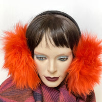 Eclection Ottawa gives you Canadian-made and cozy for winter madness! These long-haired 100% sheepskin earmuffs will have you laughing your way through the February blahs. They are fully lined with short sheepskin on the inside and have lots of nice, warm, fluffy coverage They feature a new suede-covered headband that you can wear as is or turned at 90 degrees for smaller-headed folks. Available in a rainbow of juicy colours and classic neutrals as well. Vivid orange long haired sheepskin. Black headband