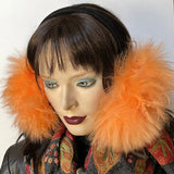 Eclection Ottawa gives you Canadian-made and cozy for winter madness! These long-haired 100% sheepskin earmuffs will have you laughing your way through the February blahs. They are fully lined with short sheepskin on the inside and have lots of nice, warm, fluffy coverage They feature a new suede-covered headband that you can wear as is or turned at 90 degrees for smaller-headed folks. Available in a rainbow of juicy colours and classic neutrals as well. Peach long haired sheepskin and black headband
