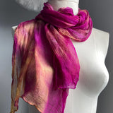 It has been created with Shibori dyeing technique on 100% pure silk crinkle chiffon and is totally unique. A piece of art to wear!  The silk chiffon is Summer weight (5 mm) and light and diaphanous with a crinkle texture that gives it body, interest, and charm. The finely finished hand-rolled piece measures flat at 22” X 72” but looks narrower with its crinkles. Mix of vibrant orchid, peaches and orange.
