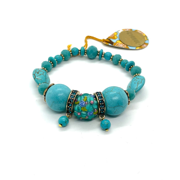 This bracelet is carefully crafted out of spherical and oval tinted howlite beads, beautifully textured lampwork glass beads, faceted crystals, tiny gold-plated flower separator beads as well as bronze separator beads. It is carefully strung by hand on a heavy and durable elastic cord for comfy wear and ease of fit. Size medium. 